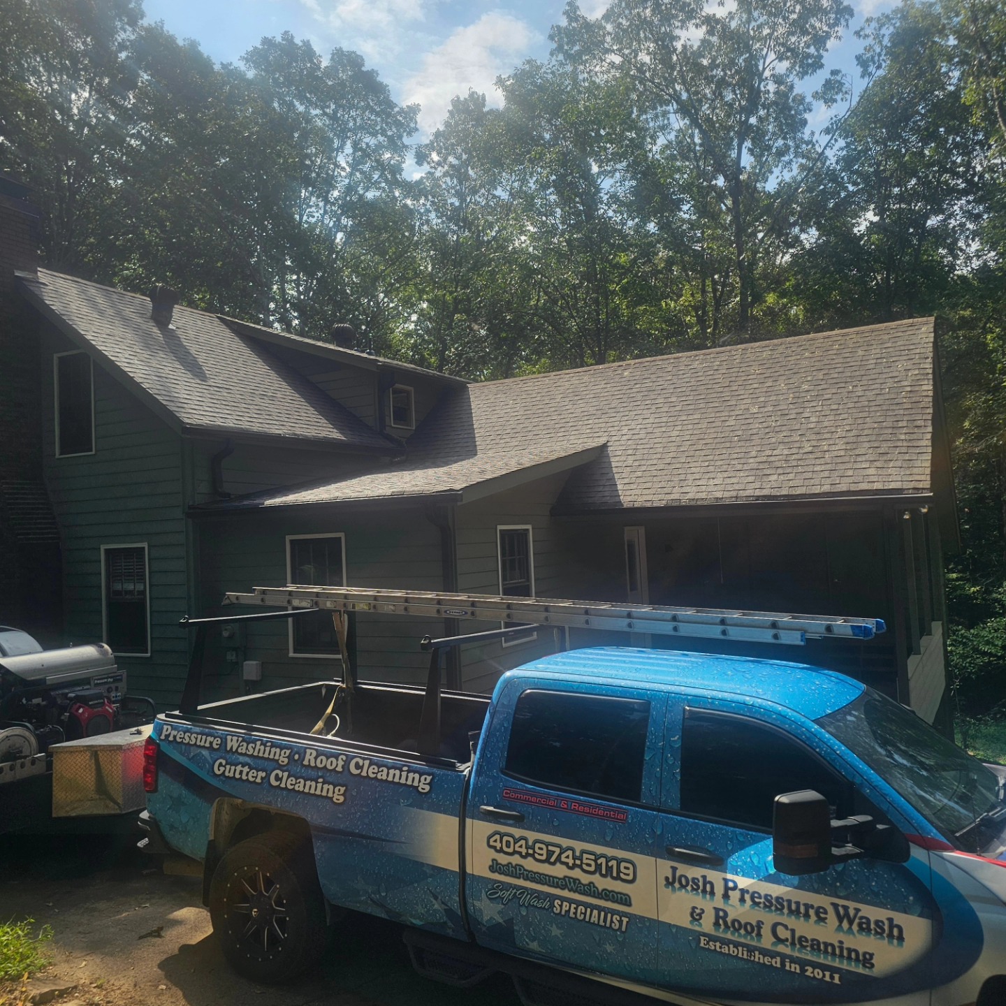 Josh Pressure Wash branded service truck at a residential job site
